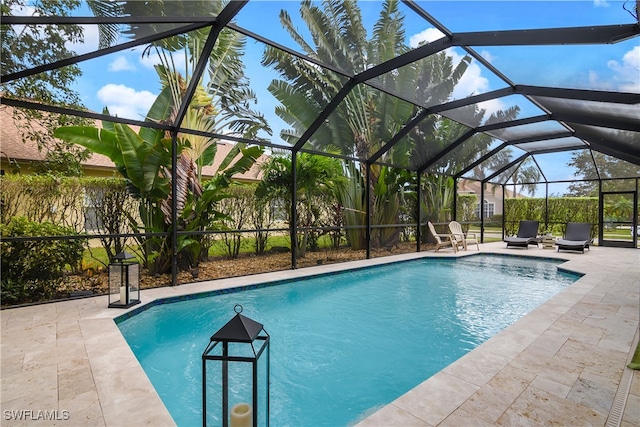 view of pool with a patio area and a lanai