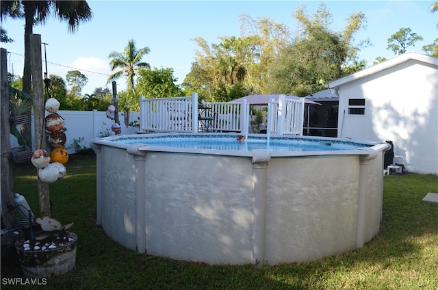 view of pool featuring a yard