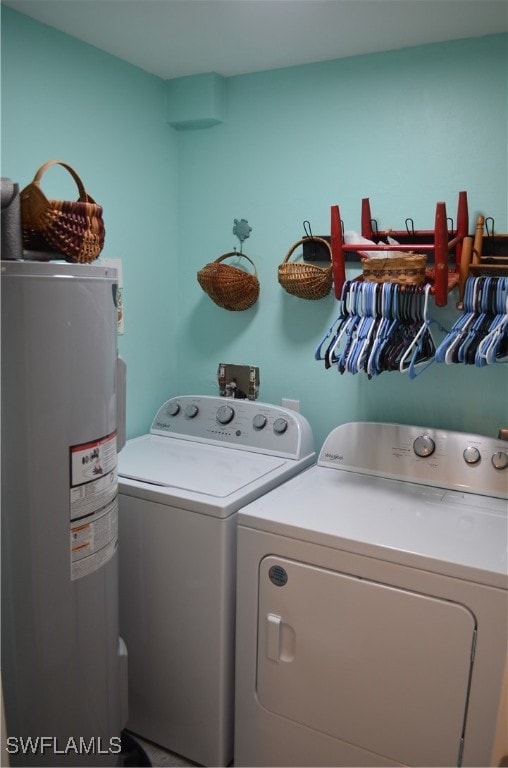 laundry room featuring water heater and washer and dryer