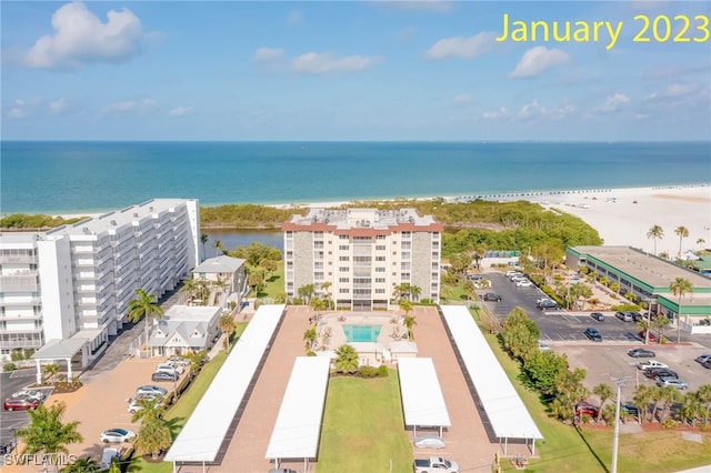 birds eye view of property featuring a view of the beach and a water view