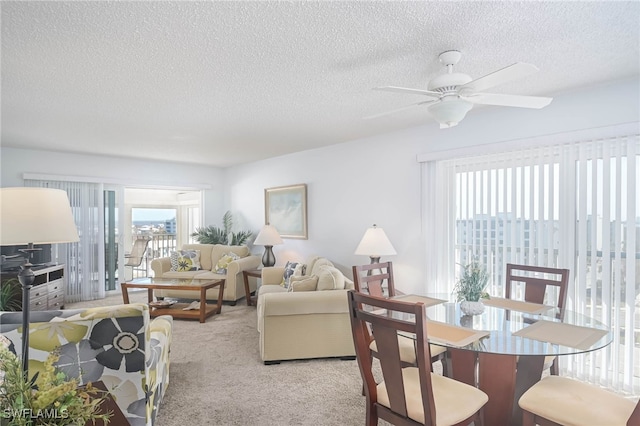 6900 Estero Blvd Unit 701, Fort Myers Beach, FL 33931 - living room with a ceiling fan, a textured ceiling, and light carpet