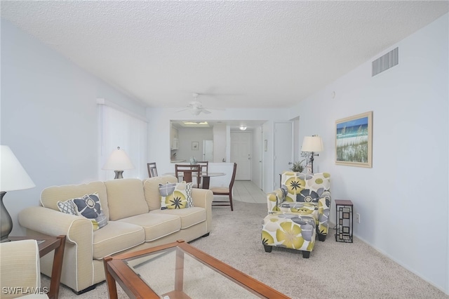 6900 Estero Blvd Unit 701, Fort Myers Beach, FL 33931 - living room featuring visible vents, a ceiling fan, a textured ceiling, and carpet floors