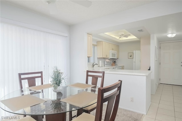 6900 Estero Blvd Unit 701, Fort Myers Beach, FL 33931 - dining room featuring visible vents, light tile patterned flooring, baseboards, a tray ceiling, and a ceiling fan