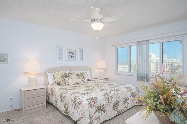 6900 Estero Blvd Unit 701, Fort Myers Beach, FL 33931 - bedroom with a textured ceiling, ceiling fan, and carpet