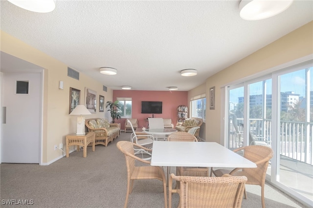 6900 Estero Blvd Unit 701, Fort Myers Beach, FL 33931 - dining area with plenty of natural light, a textured ceiling, visible vents, and light carpet