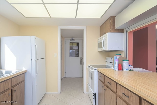 6900 Estero Blvd Unit 701, Fort Myers Beach, FL 33931 - kitchen featuring light countertops, white appliances, and light tile patterned flooring