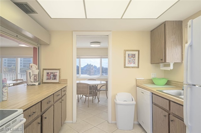6900 Estero Blvd Unit 701, Fort Myers Beach, FL 33931 - kitchen with white appliances, light tile patterned flooring, visible vents, and light countertops