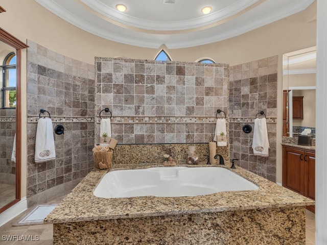 bathroom with a tray ceiling, crown molding, vanity, and separate shower and tub