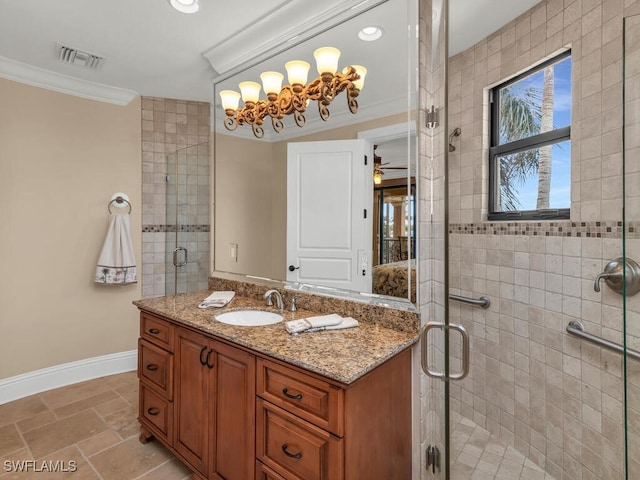 bathroom with vanity, a shower with shower door, and crown molding