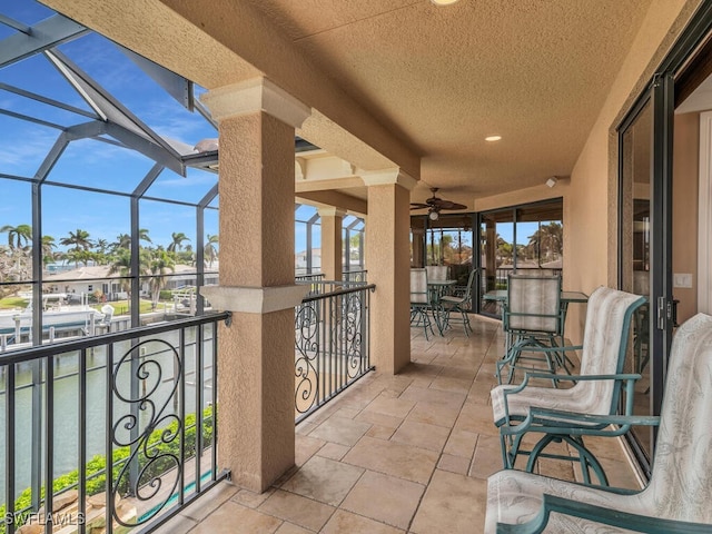 view of patio featuring glass enclosure and ceiling fan