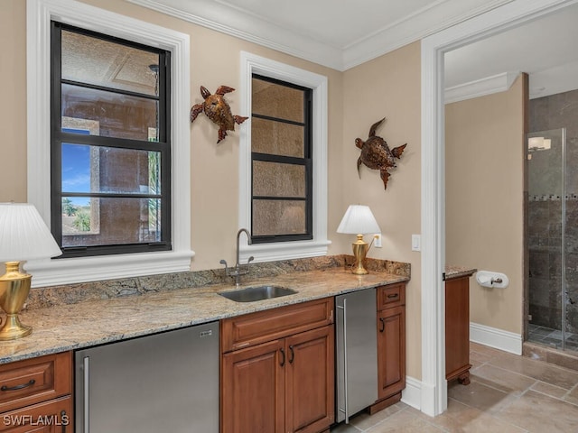 bar featuring stainless steel refrigerator, light stone counters, sink, and crown molding