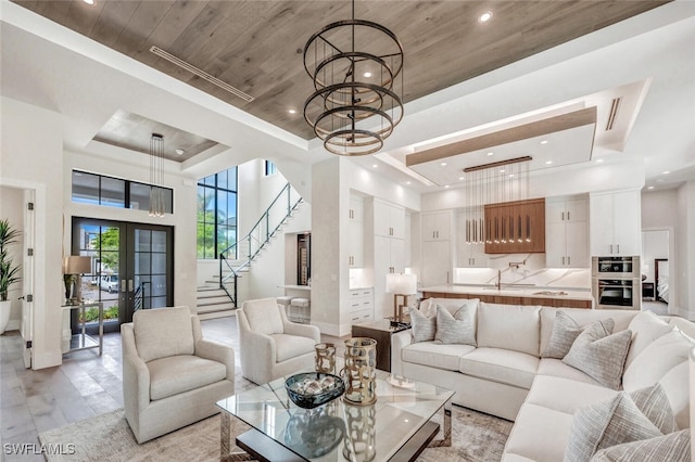 3540 Crayton Rd, Naples, FL 34103 - living area featuring a tray ceiling, a chandelier, wood ceiling, a high ceiling, and recessed lighting