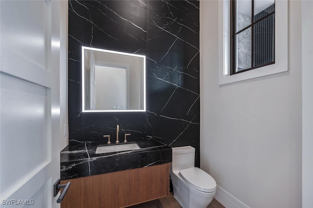 3540 Crayton Rd, Naples, FL 34103 - bathroom with vanity, toilet, and decorative backsplash