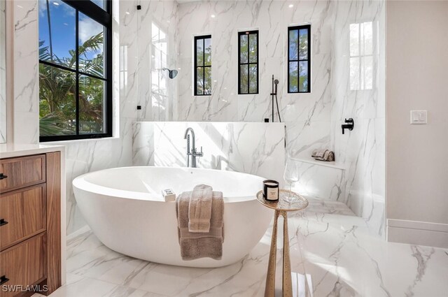 3540 Crayton Rd, Naples, FL 34103 - bathroom featuring marble tiled floors, a soaking tub, and a marble finish shower