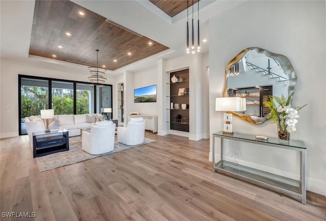 3540 Crayton Rd, Naples, FL 34103 - living area with a raised ceiling, wood ceiling, wood finished floors, baseboards, and built in shelves