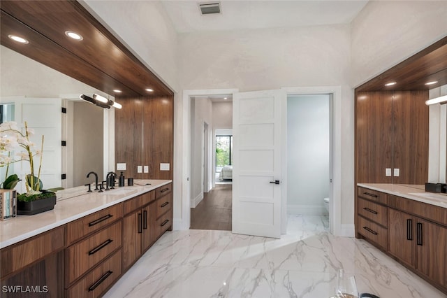 bathroom with vanity and toilet