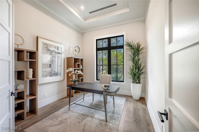 office space with hardwood / wood-style floors, a tray ceiling, french doors, and ornamental molding