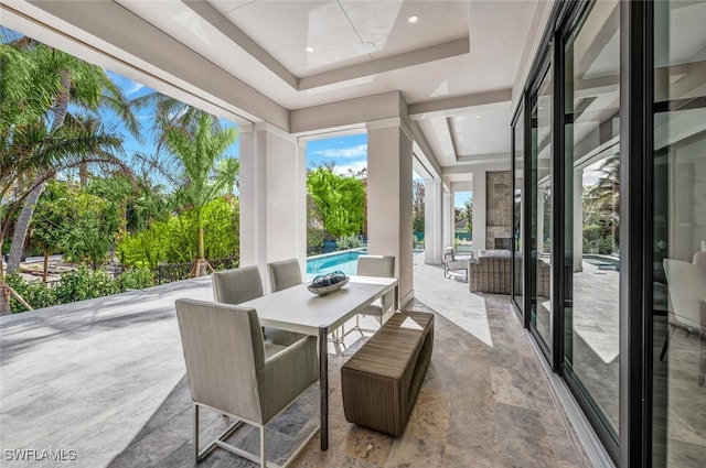 sunroom / solarium with a tray ceiling