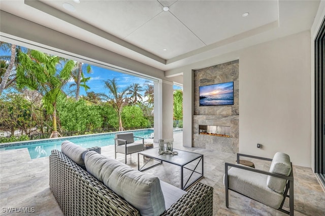 view of patio featuring an outdoor living space with a fireplace