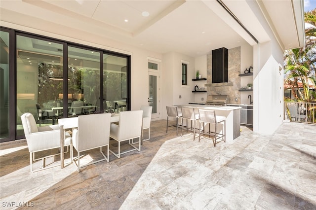 view of patio with an outdoor kitchen, a grill, and exterior bar