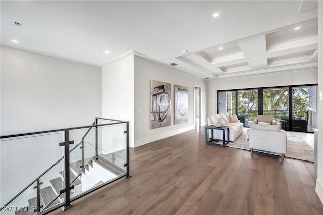 unfurnished living room featuring beamed ceiling, dark hardwood / wood-style flooring, ornamental molding, and coffered ceiling