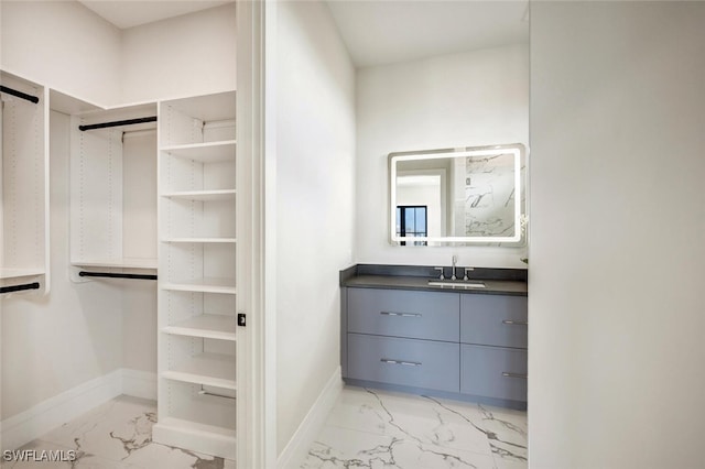 3540 Crayton Rd, Naples, FL 34103 - walk in closet featuring light marble finish floors and a sink