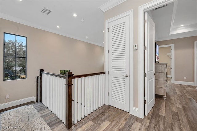 hall featuring crown molding and hardwood / wood-style flooring