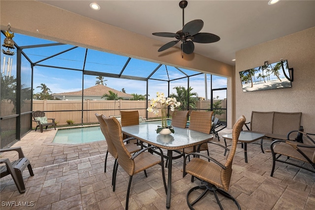 view of patio / terrace with ceiling fan, a lanai, and a fenced in pool