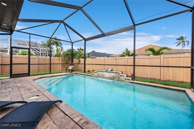 view of swimming pool with pool water feature, a lanai, and a patio area