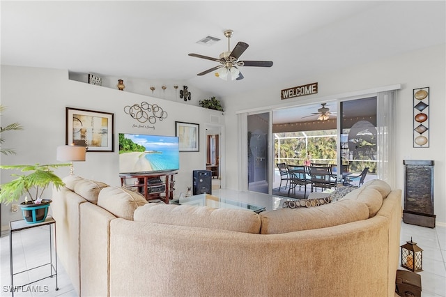 living room with light tile patterned floors, ceiling fan, and vaulted ceiling