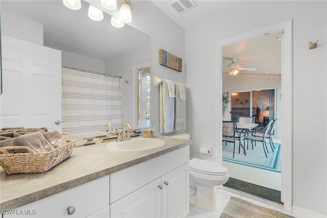 bathroom featuring ceiling fan, tile patterned floors, vanity, and toilet