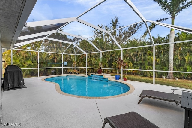 view of pool with a lanai and a patio area