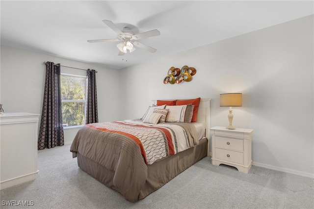 bedroom with ceiling fan and light carpet