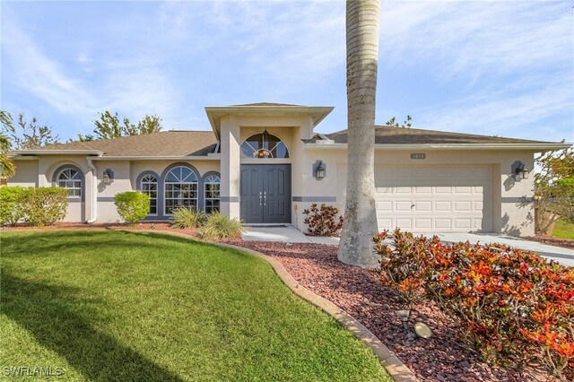 view of front of home featuring a garage and a front yard