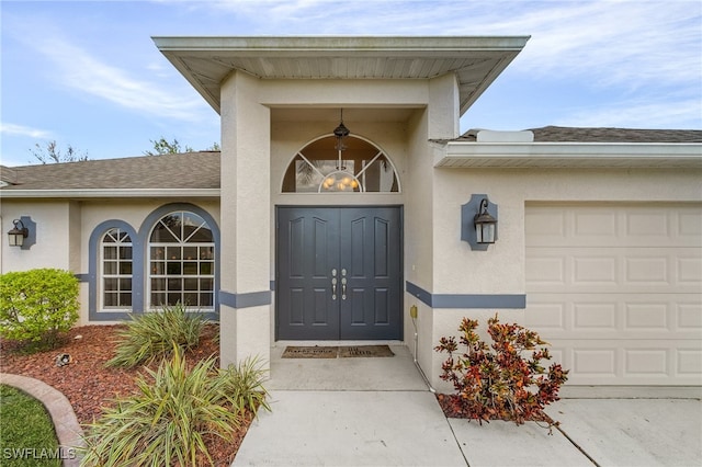 view of exterior entry featuring a garage