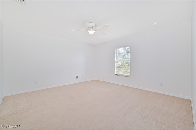 carpeted empty room with ceiling fan