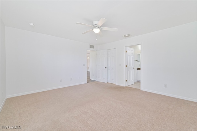 carpeted spare room with ceiling fan