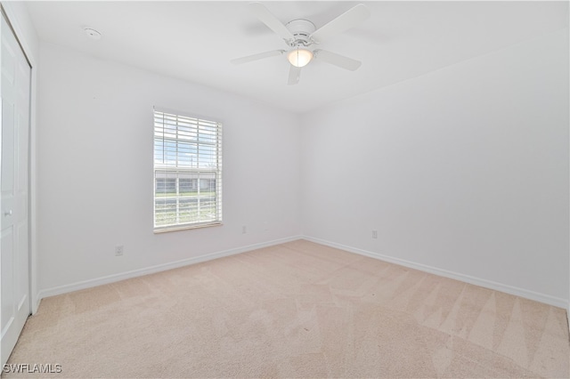 carpeted empty room with ceiling fan