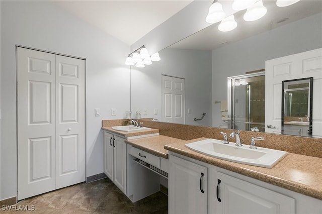 bathroom featuring tile patterned flooring, vanity, and a shower with door