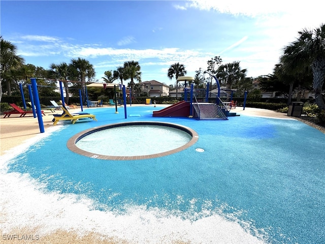 view of swimming pool featuring a playground