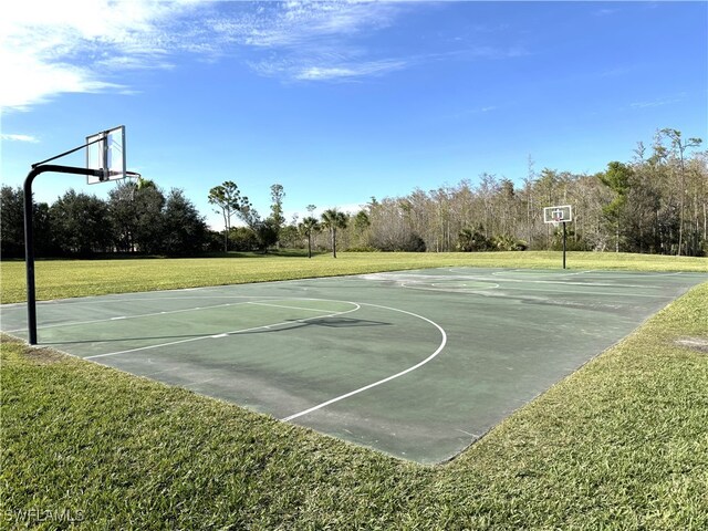 view of basketball court featuring a lawn