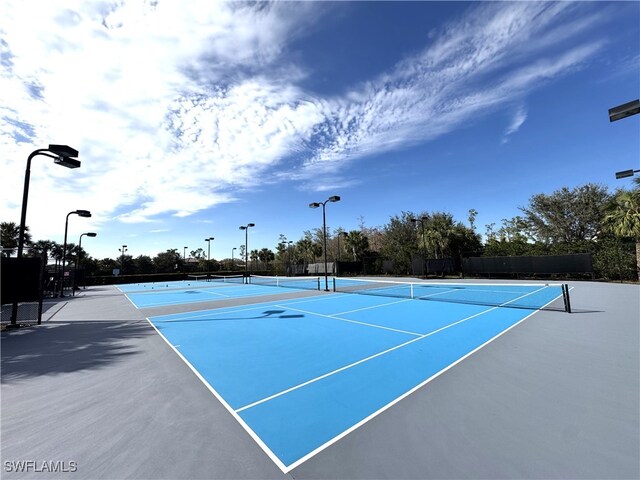 view of tennis court featuring basketball hoop