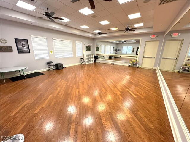 workout area with a drop ceiling and hardwood / wood-style flooring