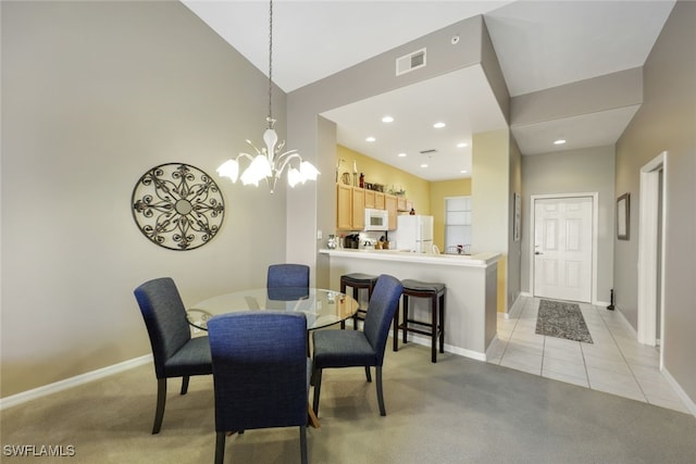 carpeted dining space featuring a notable chandelier