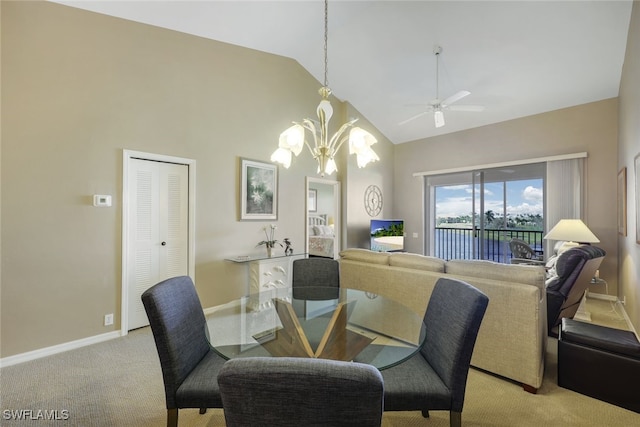 carpeted dining space featuring high vaulted ceiling and ceiling fan with notable chandelier