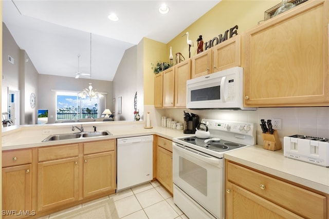 kitchen featuring sink, vaulted ceiling, a notable chandelier, light brown cabinetry, and white appliances