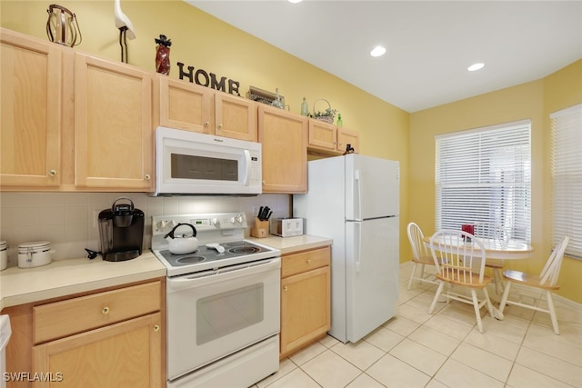 kitchen featuring light tile patterned floors, light brown cabinets, white appliances, and tasteful backsplash