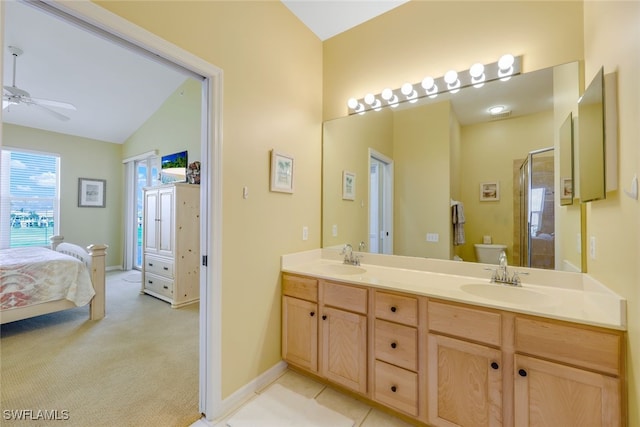 bathroom featuring ceiling fan, vaulted ceiling, toilet, vanity, and an enclosed shower