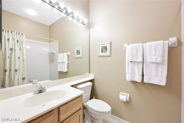 bathroom featuring vanity, curtained shower, and toilet