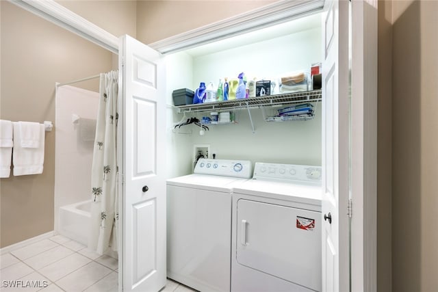 laundry area with washer and dryer and light tile patterned flooring